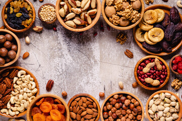 Various Nuts and dried fruits in wooden bowls.
