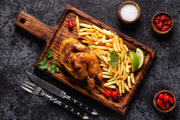 Half roasted chicken Piri Piri with french fries © tbralnina