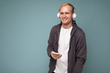 young man wearing casual white t-shirt isolated over blue background
