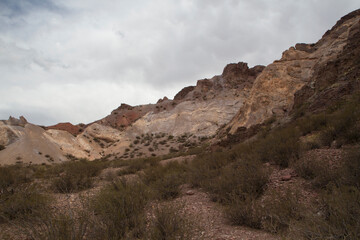 Unique rock formations in the desert. View of the canyon, sand, sandstone hills and desert flora in Uspallata, Mendoza, Argentina. 