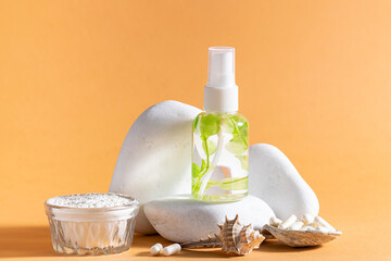 Set of organic skin care cosmetic with sea plant extract and sea collagen on white stone podium on light beige background.