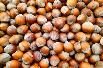 Close-up on a stack of hazelnuts on a market stall.