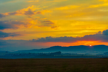 Golden and colorful sunset orange yellow red blue pink colors.