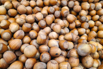 Close-up on a stack of hazelnuts on a market stall.