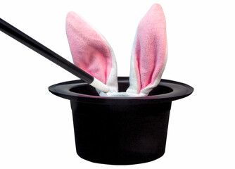 Black magician's hat with magic wand and pink toy bunny ears. Isolated.
