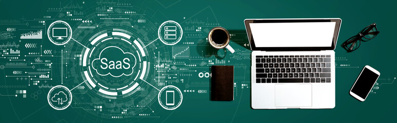 SaaS - software as a service concept with a laptop computer on a desk