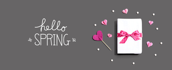 Fototapeta na wymiar Hello spring message with a gift box and paper hearts