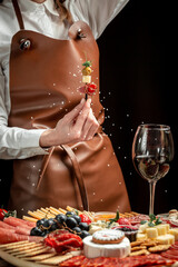 Woman holding delicious appetiser Italian prosciutto and Spanish Iberian ham snack