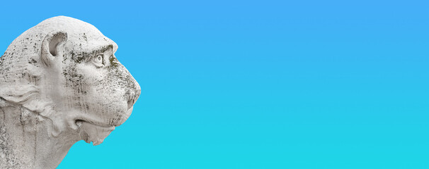 Obraz premium Banner with ancient Venetian Piraeus lion head near Arsenal in Venice with copy space for text and gradient sky background, Italy, closeup, details. Concept art and historical places heritage.
