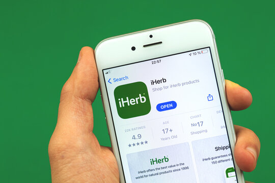 Kharkov, Ukraine - February 28, 2021: iHerb website application o Apple iPhone screen, App store close up