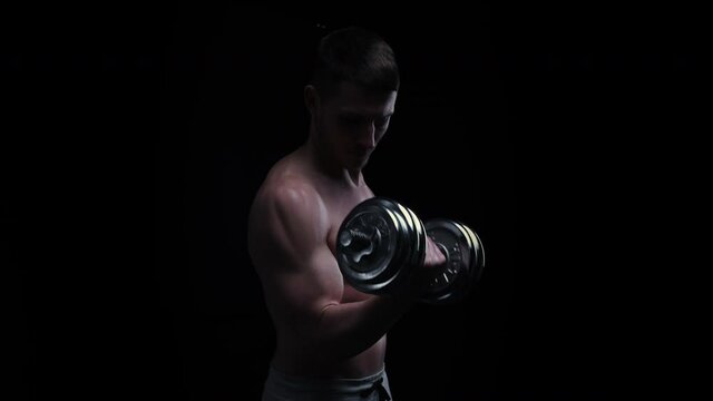 Man Pumping Biceps with Dumbbell Topless. Sprotsman Doing Traning on Biceps Muscles. Gym, Lifting Sport Concept. Sport Body.
