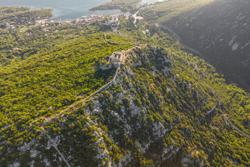 Aerial drone shot of City Wall of Ston over hill to Mali Ston in Croatia summer morning sunrise