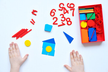 The child learns Number line and geometric shapes. The preschooler works with Montessori material. Educational logic toys for kid's. Children's hands close-up. Montessori Games for Child Development.