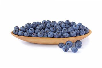 Blueberries on a wooden plate  isolated on white