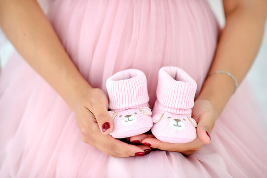 pregnant belly and pink booties