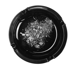 Black glass ashtray with cigarette stubs, butts with ash isolated on white background, top view