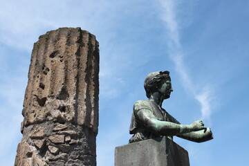 Ancient column and sculpture . Pompeii. Italy
