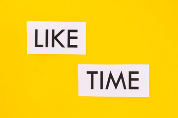 text LIKE TIME on white paper on a yellow background.Social media concept.