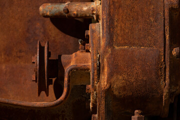 Rusty metal parts belonging to an old abandoned and disused tractor, formerly used in the agronomic industry, near Campo de Borja, Zaragoza province, Aragon, Spain.