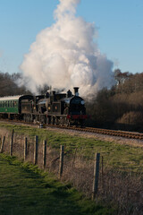 Obraz na płótnie Canvas a double headed steam train leaves Norden on the Swanage Heritage Railway 