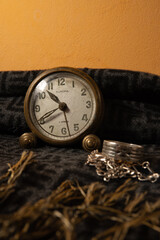 Still life with antique clock, elephant figurine and silver ring