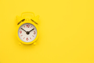 Yellow alarm clock Isolated on yellow trendy background. Rest hours time of life good morning night...