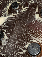 the heart sign painted on the soap stains from the foam. Cleaning the kitchen surface. Valentine's Day. Love for cleaning and cleanliness
