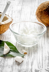organic cosmetics with coconut on wooden background close up