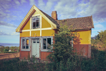 Abandoned yellow house in spring.