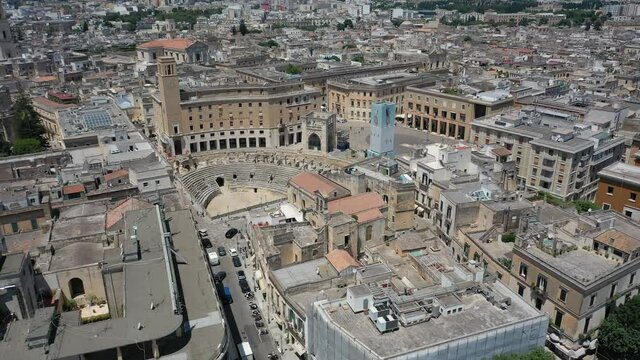 Lecce,Puglia,Italy Beautiful panoramic aerial 4K video from flying drone to Roman Amphitheatre, arena Lecce. Historic city center, Cathedral of Maria Santissima Assunta, on a beautiful summer day.