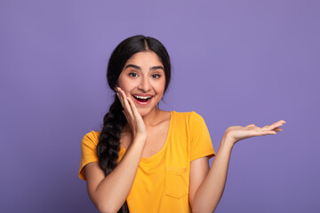 Happy young indian woman showing copy space