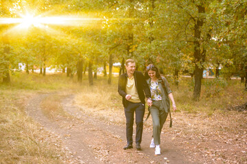 Fototapeta premium young couple of man and woman having fun and enjoy themselves outdoor on the autumn day