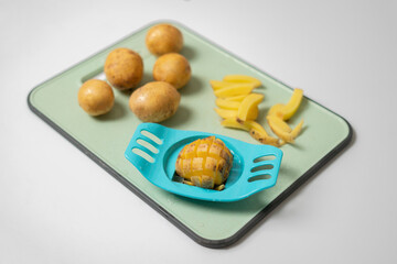 the device potato push  cutter. on the desk, making the rustic fried french