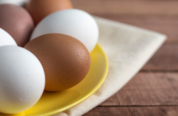 yellow plate with whole eggs on a napkin, close-up with a copy of the space