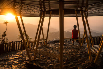 A person watching the dramatic summer sunrise in Mines View Park  in the Summer Capital of the Philippines , Baguio City.