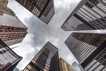 A low angle view of skyscrapers on an grey overcast day.