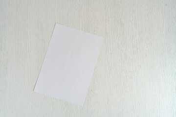 blank empty white paper sheet of a4 format on the table in office, mockup copy space