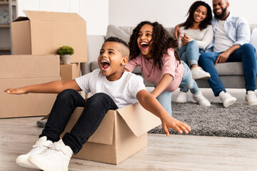 Happy African American family celebrating moving day in new apartment - obrazy, fototapety, plakaty