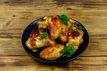 Baked chicken wings on a wooden table