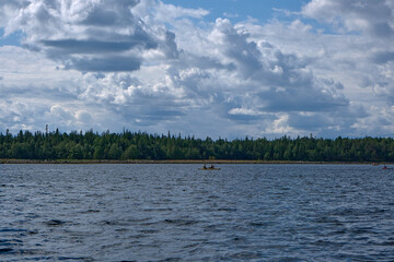Tourists sail in a kayak in the northern sea.