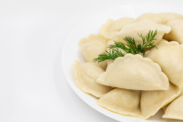 Boiled dumplings with potatoes. Traditional Ukrainian and Russian food. White background.