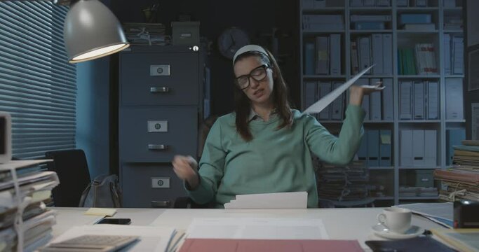 Exhausted office worker throwing away paperwork