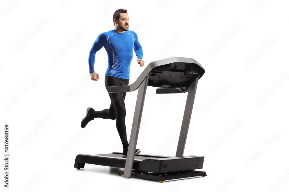 Poster full length shot of a fit young man in sportswear running on a treadmill