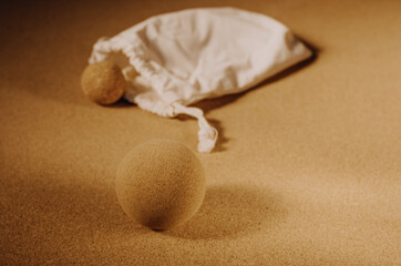 Close up of fascia release cork massage ball a cork mat background, warm golden light. Concept: eco friendly and sustainable self care tools, props.