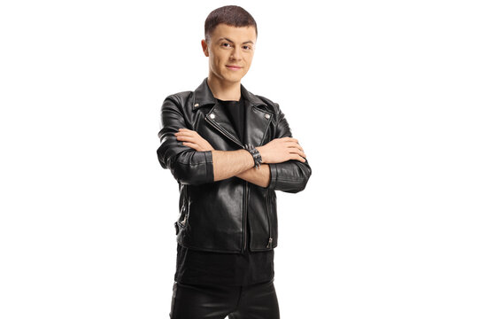 Young male in leather jacket and pants posing with crossed arms