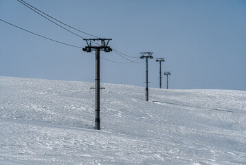 Resorts of the North Caucasus. The northern slope of the Arkhyz ski resort. Ski lift. White and blue winter landscape.
