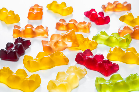 Gummy bear candy in white backdrop. THD or cbd cannabis sweets in form of gelatine gummi bears, calming edible food supplements