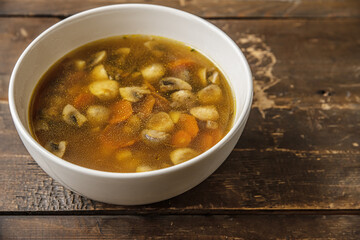 homemade champignon soup in a ceramic bowl on a wooden table