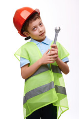 Preschool child construction worker in orange helmet holding wrench on white isolated background