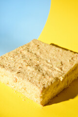 Napoleon cake on a yellow background. Shot from the side. Place for the logo